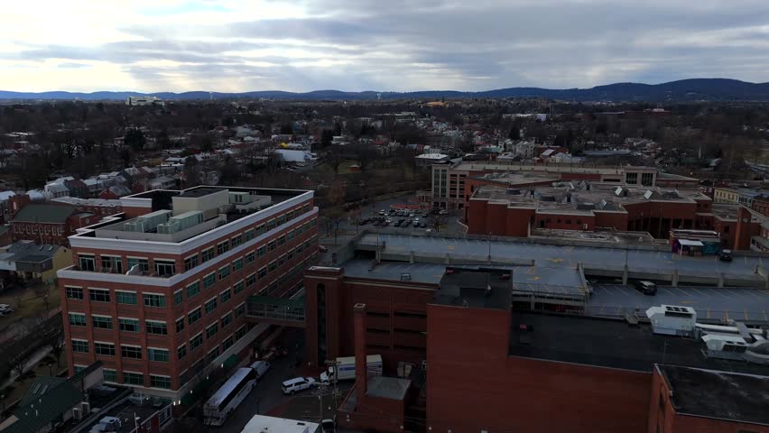 Drone view of rooftop parking deck and brick buildings in Frederick Maryland