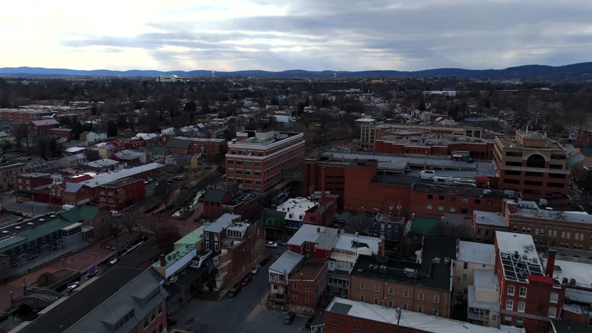 Drone view of urban brick buildings with hills in Frederick Maryland