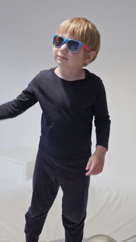 Child playing with balloons on bed