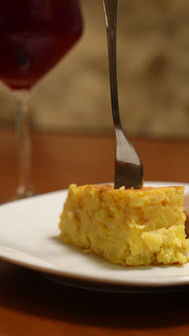 High-resolution photo of a traditional Spanish potato omelette served on a rustic plate. Classic homemade dish widely enjoyed in Spanish bars and households, ideal for food, travel, and lifestyle concepts.