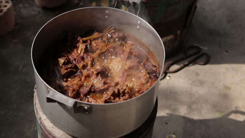 A large pot of traditional Vietnamese beef stew simmering on a stove with rich gravy and tender meat
