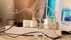 Hand Organizing Tangled Smartphone Charger Cable on Power Strip - Powered by Shutterstock - Get 15% off with code: PIKWIZARD15