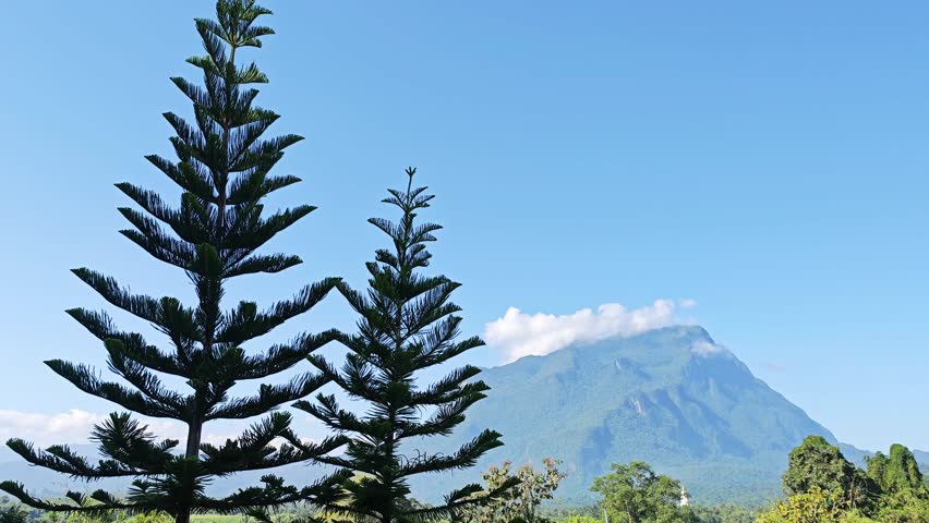 A peaceful mountain landscape under a clear blue sky.