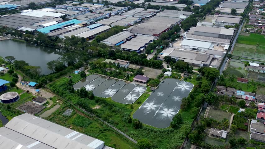 Aerial Water Ponds Near Industrial Area with Green Landscape and Infrastructure