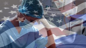 Animation of flag of usa waving over surgeons in operating theatre. Global medicine healthcare services during covid pandemic concept digitally generated video. - Powered by Shutterstock - Get 15% off with code: PIKWIZARD15