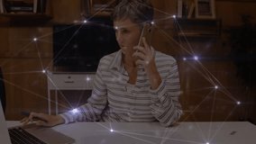 Network of connections over caucasian senior businesswoman using laptop and talking on smartphone. Global networking and business technology concept - Powered by Shutterstock - Get 15% off with code: PIKWIZARD15