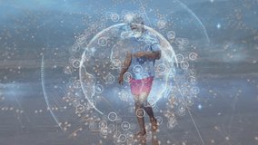 Animation of spinning globe with data processing, blue rays against african man walking at beach. Digital composite, multiple exposure, digital interface, technology, global science, wellbeing. - Powered by Shutterstock - Get 15% off with code: PIKWIZARD15