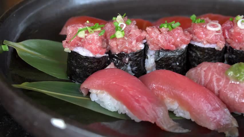 Close-up of assorted tuna sushi on a plate, highlighting fresh seafood, Japanese cuisine, culinary presentation, and gourmet dining experience.