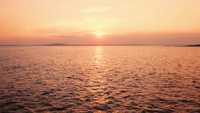 Beautiful sunset over the sea with orange sky and sun reflecting on the water, capturing serene ocean views, natural beauty, and peaceful atmosphere.