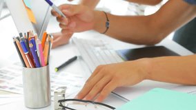 A creative designer is helping her colleague with a project in the office. Global business networking and digital interface concept digitally generated video. - Powered by Shutterstock - Get 15% off with code: PIKWIZARD15