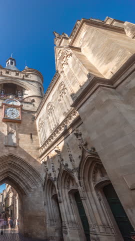 Porte Saint Eloi timelapse hyperlapse, also called Grosse Cloche, is a medieval gothic gate in Bordeaux, France. A symbol of the city's history with a big bell and clock. Blue sky enhances its beauty