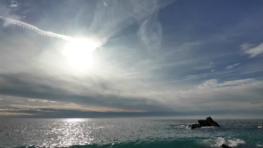 Soft waves roll onto sandy beach in winter coastal village Bogliasco.