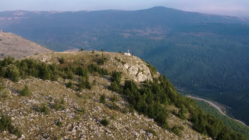 Aerial view of a rocky mountain ridge in Bosnia and Herzegovina in 2019, showing steep slopes, cliffs and wide mountainous landscape in the distance.