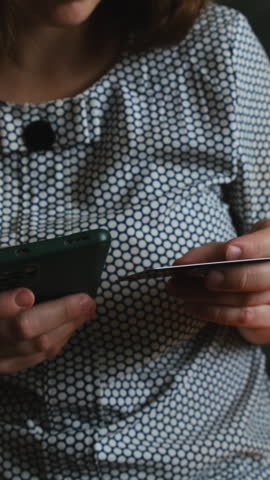 Vertical video. Online payments using credit bank card and mobile phone. Money transfer, shopping online, e-commerce purchase.