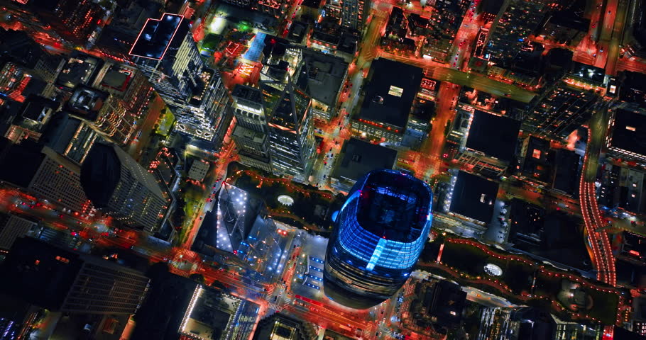 Flying high over the skyscrapers of San Francisco, California, USA. Luminous streets with lively traffic at night.