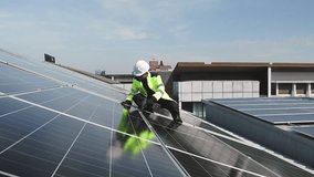 Technician installing solar panels on factory roof for green energy. A skilled technician in safety gear is working on a solar panel installation on rooftop. clean energy renewable power technology. - Powered by Shutterstock - Get 15% off with code: PIKWIZARD15