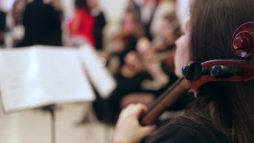 Female Cellist Performing with a String Ensemble