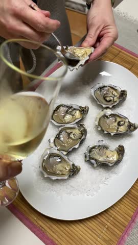 Woman Opening and Preparing Fresh Oysters to Serve