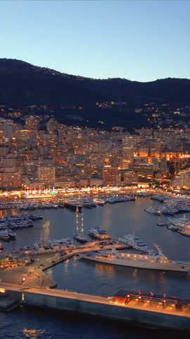 Aerial Vertical Cityscape Golden Hour Over Facades, Hillside Skyline And Coastal Bay Drone Sweeps Across Ornate Palace. Monaco