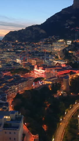 Aerial Vertical Cityscape Golden Hour Over Facades, Hillside Skyline And Coastal Bay Drone Sweeps Across Ornate Palace. Monaco