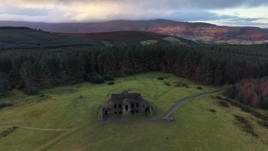 Orbital-style aerial view of Dublin’s Hellfire Club, a ruined Palladian hunting lodge on Montpelier Hill, overlooking the Dublin Mountains in Ireland.
