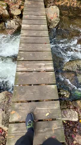 Crossing a Stream in the Woods on a Wooden Footbridge on the Jordan Cliffs Trail (Acadia National Park, Maine, USA)