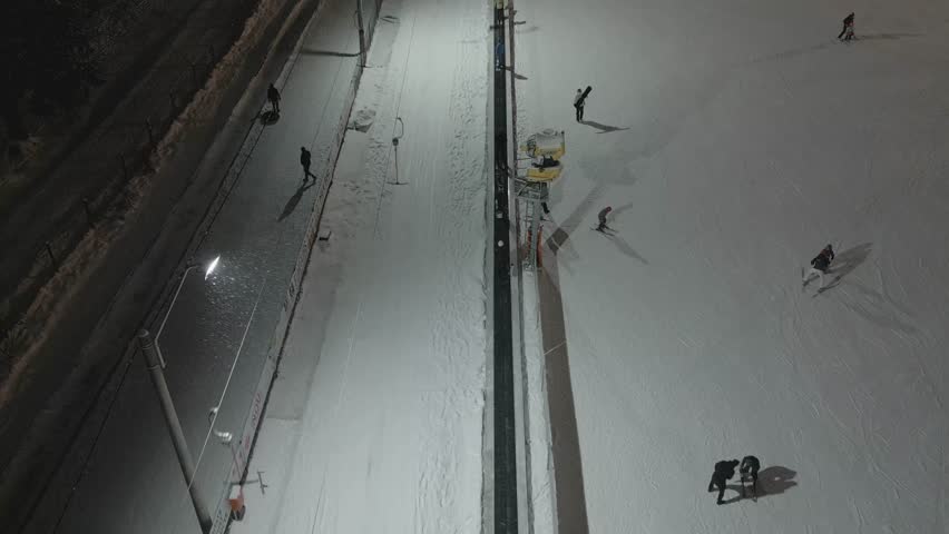 Night Ski Slope Aerial View With Skiers Under Floodlights