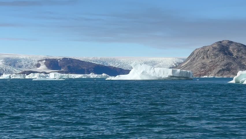 Experience the breathtaking beauty of Greenland’s Arctic landscape, where massive glaciers and towering icebergs float gracefully in pristine, turquoise waters. This serene yet dramatic scene highlights the raw power and untouched majesty of the polar regions, perfect for themes of nature, climate, adventure, and Arctic exploration.