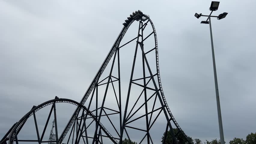 Energylandia, high-speed roller coaster climbs steep track at an amusement park