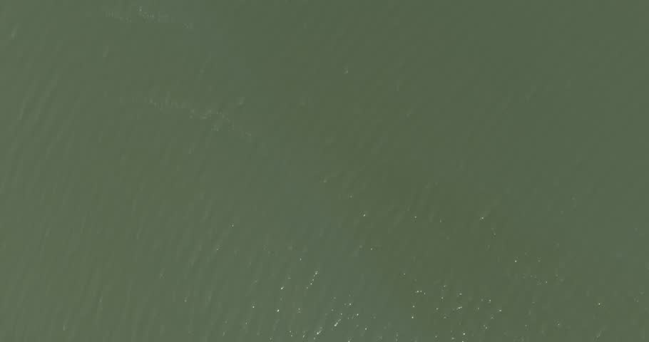 Aerial view of Suomenoja Marina, featuring numerous sailboats and yachts docked along a pier in summer, Espoo, Finland.