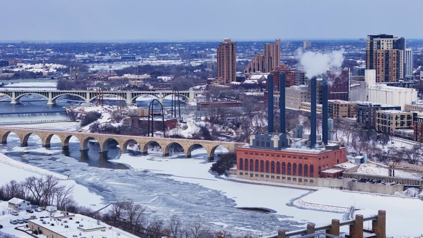 University of Minnesota Southeast Steamplant with Historic Stone Arch Bridge in Minneapolis, USA