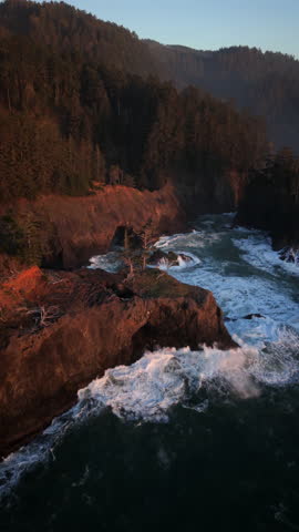 Powerful Pacific Ocean waves crash through Natural bridges along the Oregon Coast, showcasing coastal erosion, rugged cliffs, dramatic seascape, raw nature, and motion