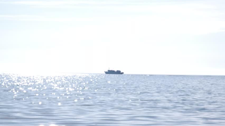 Alone sailboat floating in vast open sea under serene blue sky, tranquil ethereal view, maritime. 