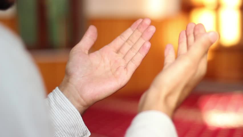 Close-up of a Muslim man praying, showing devotion, spirituality, and religious practice, capturing a moment of faith and reflection.