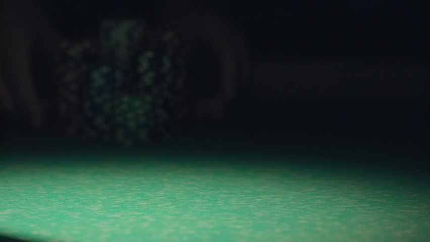 Poker chips stacked on a game table, capturing casino gameplay, gambling, card games, and the excitement of a poker session.