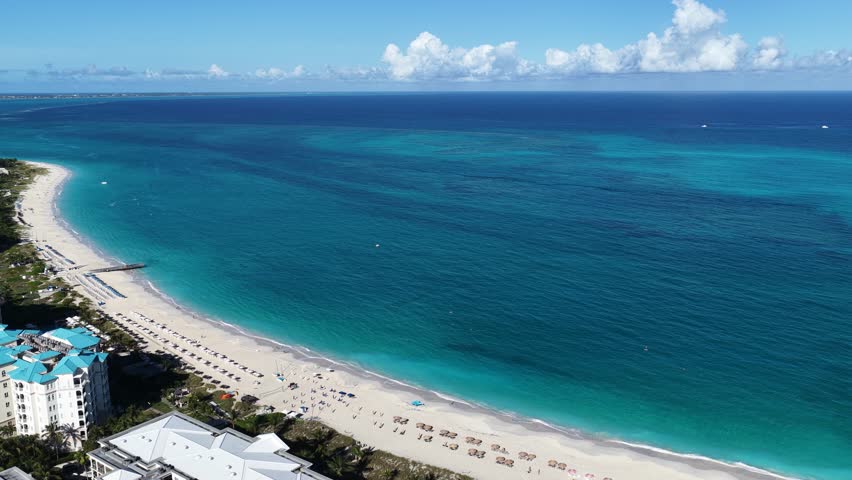 Grace Bay At Turks And Caicos In Overseas Territory United Kingdom. Caribbean Skyline. Beach Landscape. Highrise Buildings. Grace Bay In United Kingdom. Nature Background