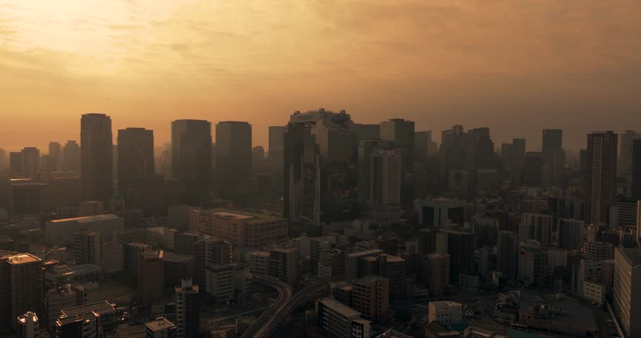 Aerial view of city skyline with skyscrapers, buildings, and urban architecture in Osaka City during sunrise. Osaka, Japan.