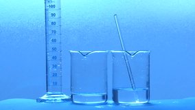 Chemist's hand pouring transparent liquid between beakers for a scientific experiment in a lab - Powered by Shutterstock - Get 15% off with code: PIKWIZARD15