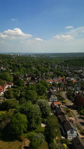 Sunny drone view over lush suburban Sheffield, Yorkshire homes and greenery