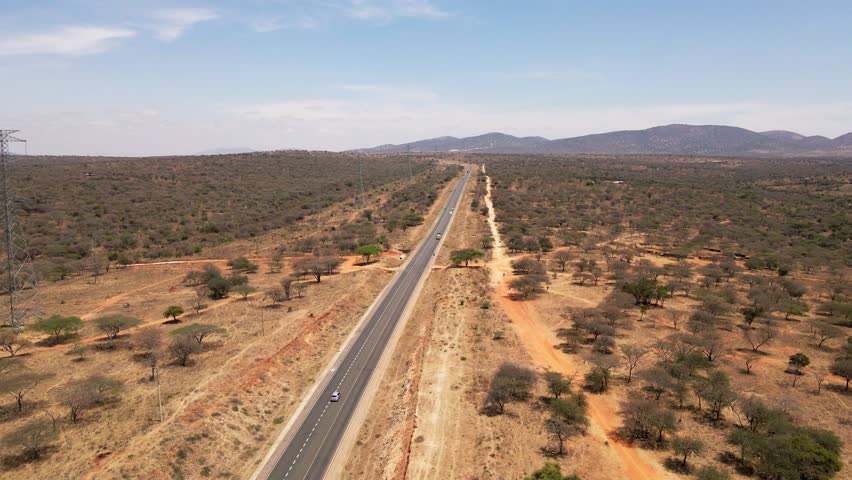 Straight road through African savannah in Kenya