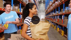 Animation of network of connections with icons over diverse volunteers working in warehouse. Global shipping, connections, business, computing and data processing concept digitally generated video. - Powered by Shutterstock - Get 15% off with code: PIKWIZARD15