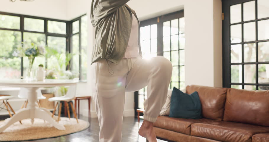 Senior woman, exercise and marching in home for cardio, warm up or low impact aerobic conditioning. Fitness, smile and elderly person training in living room for wellness, body health and retirement