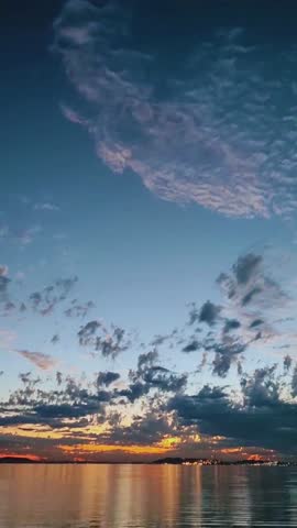 Romantic tropical sunset with blue and red magical sky over calm sea.
