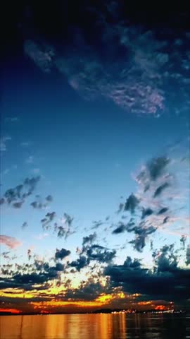 Romantic tropical sunset with blue and red magical sky over calm sea.