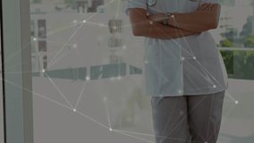 Camera panning back revealing medical doctor standing by balcony, network pulsing showing data flow. Futuristic, innovation, technology, healthcare, professionalism, leadership, connectivity - Powered by Shutterstock - Get 15% off with code: PIKWIZARD15