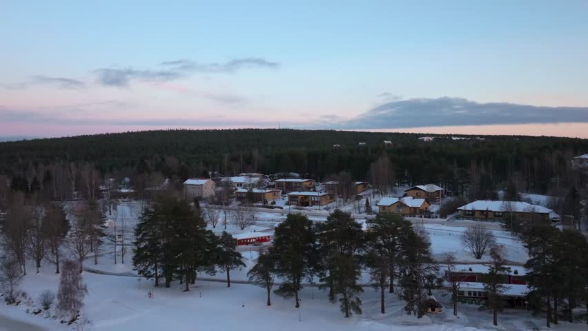 4K cinematic drone footage of Rovaniemi, Finland, captured at golden hour during the winter solstice_77