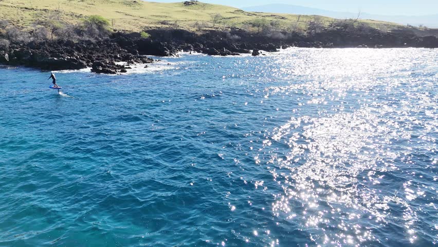 Aerial view of a man on an electric hydofoil board, United States.