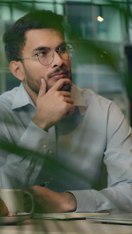 Ethnic Indian business man thinking come up with idea writing notes businessman concentration working project analyze Arabian entrepreneur think decide finding answer insight male guy at cafe table