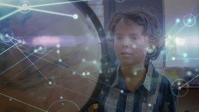 Animation of network of connections over caucasian schoolboy with globe. global connections, networks, education and travel concept digitally generated video. - Powered by Shutterstock - Get 15% off with code: PIKWIZARD15