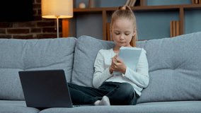 Caucasian little cute school child girl kid e-learning raising hand arm ready to answer online tutor e-learning at home listening study lesson with computer and copybook on couch quarantine isolation - Powered by Shutterstock - Get 15% off with code: PIKWIZARD15